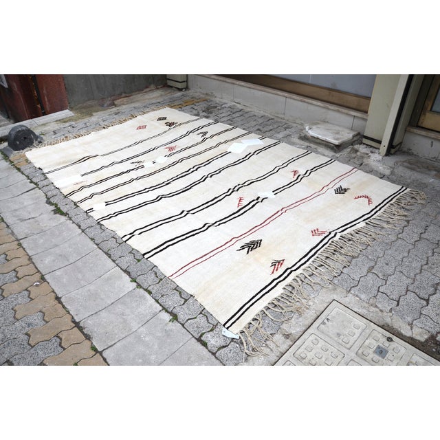 This is a vintage Turkish Oushak rug from the 1960s. The piece was hand-knotted.