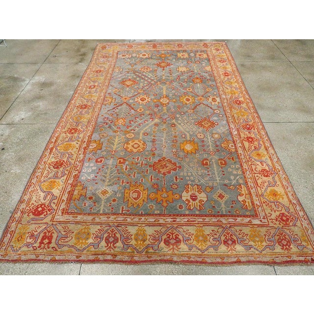 An antique Turkish Oushak room size carpet handmade during the Early 20th century. Measures: 8' 6" x 14' 5"