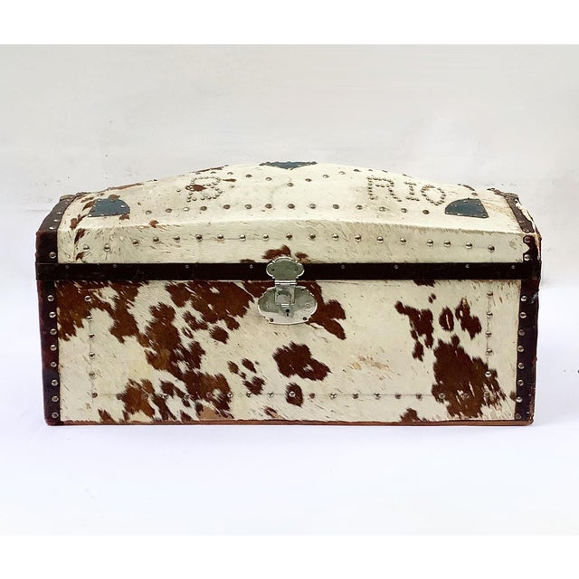 Circa 1940s cowhide trunk, top is decorated with tacks, a heart and "B R10". Inside has original tray covered with bunnies...