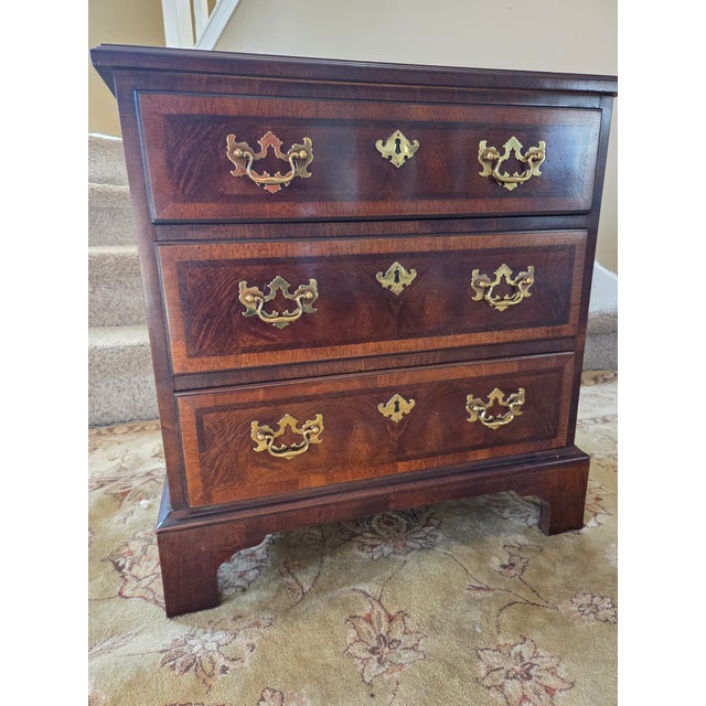 Beautiful Chippendale 3 drawer nightstand made of solid wood with burl mahogany veneers made by Henredon from their Aston...