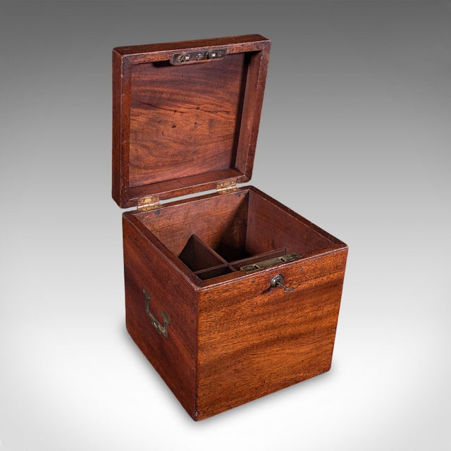 This is an antique four decanter box. An English, mahogany spirit or whiskey bottle case with Bramah lock, dating to the...