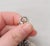 This is part of Chairish’s Costume Jewelry assortment. Rhodium plated Floretine finish bell charm with a faceted glass...