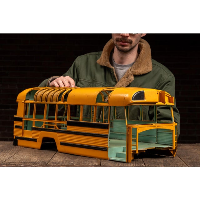 Painted metal salesman sample model of a school bus body, finished in classic yellow with black beltline striping and a...