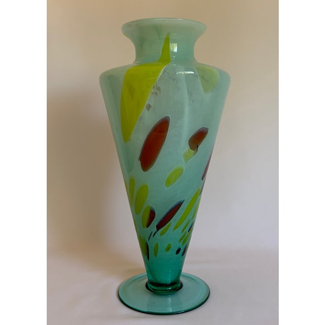 A striking vintage Murano art glass vase by Milano Lavorazione, featuring a translucent aqua-blue body with expressive...