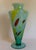 A striking vintage Murano art glass vase by Milano Lavorazione, featuring a translucent aqua-blue body with expressive...
