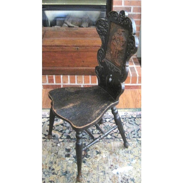 Antique leather embossed accent chair. Leather panel depicting a courting couple. 16" wide 20" deep 39" tall, seat height...