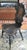 Antique leather embossed accent chair. Leather panel depicting a courting couple. 16" wide 20" deep 39" tall, seat height...