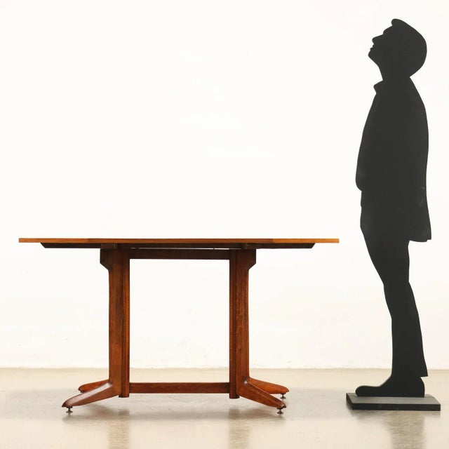 Table with base in stained beech wood and top in teak veneer. Restored. This piece is attributed to the mentioned...