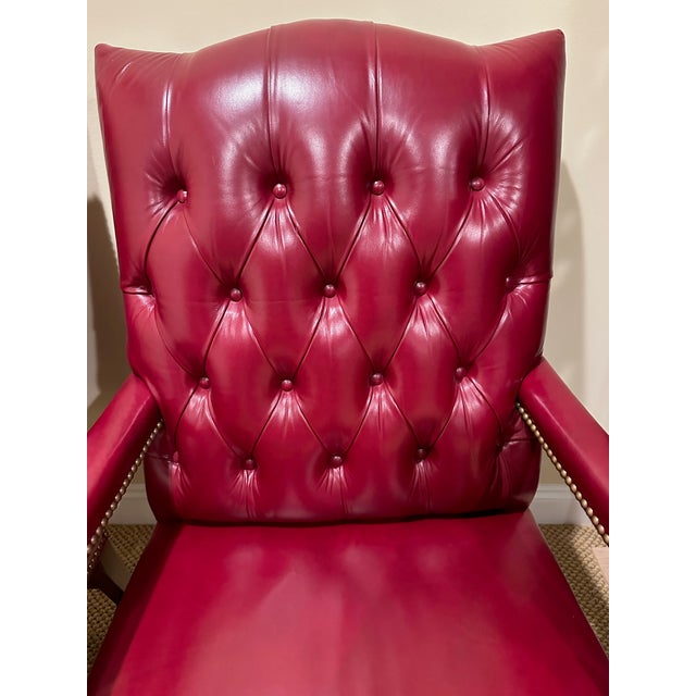 Pair of Hancock & Moore classic tufted red leather Chesterfield style arm chairs. Seat: 17” D x 17” H Arm: 26” H Seip