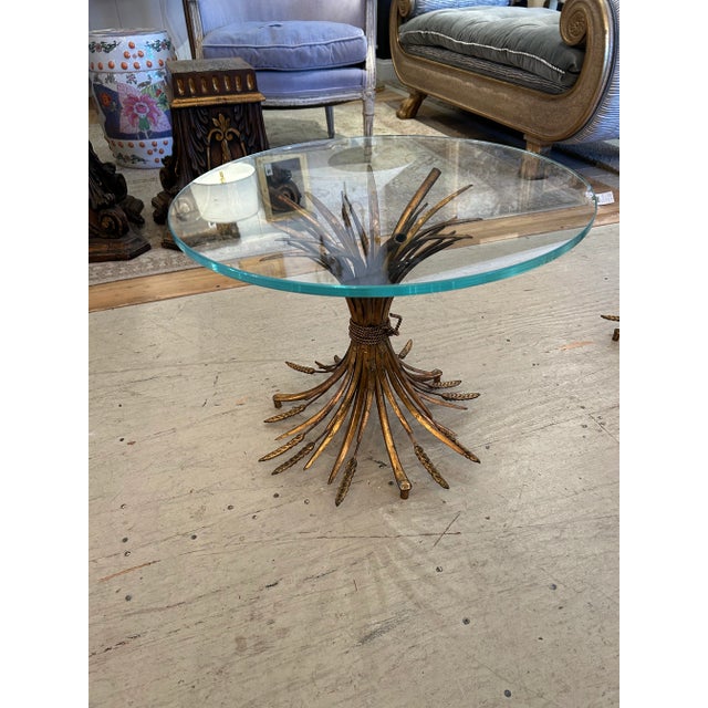 Timelessly glamorous gilt metal wheat sheaf motif end tables having new thick tempered glass tops. Details Dimensions...