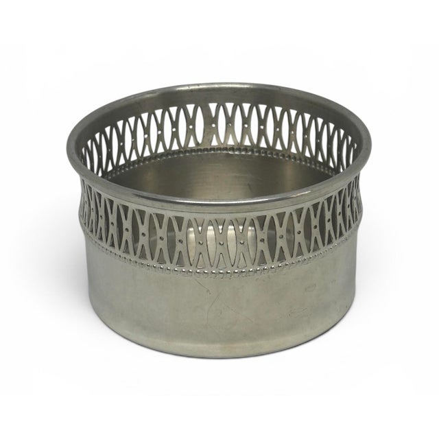 This item is a vintage Eastern Pewter wine or champagne bottle coaster featuring a polished metallic finish. It features a...