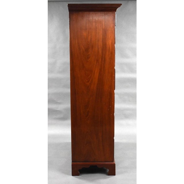 A good quality George III mahogany tallboy, having a flared cornice, above an arrangement of 7 graduated drawers, each...