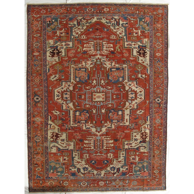 Antique Hand-knotted Persian Serapi rug from northwest Iran, known for its bold geometric design and durable construction....