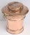 A large English urn or bin of copper, featuring a raised hinged lid with a decorative relief design, mounted to a circular...