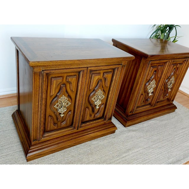 Beautiful matching pair of vintage Unique Furniture Bolero II nightstands featuring carved walnut cabinet doors, original...
