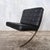 An iconic mid century style Barcelona chair , beautifully upholstered in supple black leather and mounted on a polished...
