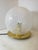 Table lamp by Ornella Noorda for Venini. Brass base and handcrafted glass globe, created by joining alternating white and...