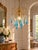 A striking vintage waterfall chandelier featuring 14 elongated turquoise-blue glass teardrops and 14 clear faceted...