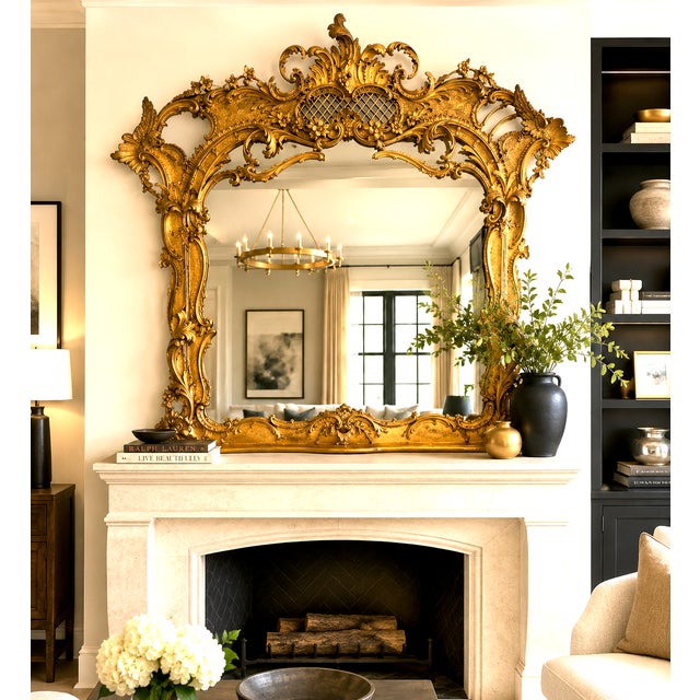 An extraordinary and highly decorative&nbsp;English Rococo carved and giltwood overmantel mirror, distinguished by its...