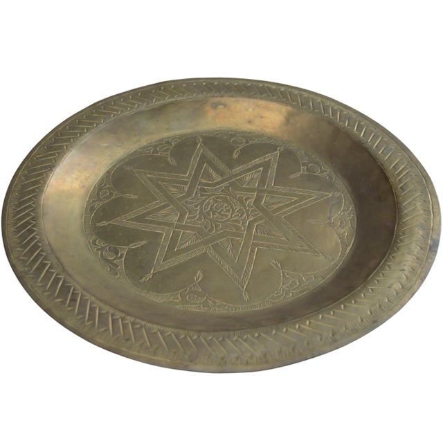 Mid-Century hand-engraved and detailed Moroccan brass tray featuring ornate moorish pattern. Hook on reverse for hanging....