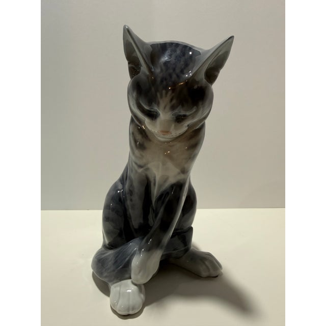 Vintage Royal Copenhagen porcelain figurines including a seated gray cat and a pair of geese, both made in Denmark and...