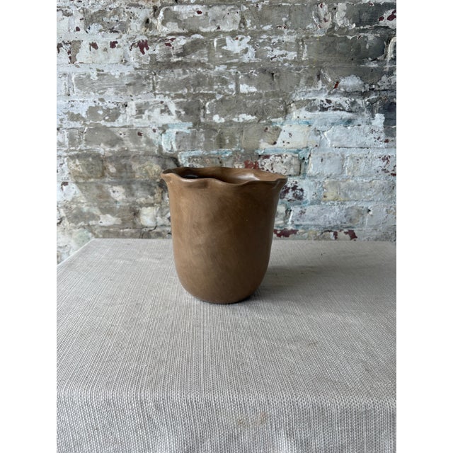 Elegant contemporary ceramic vase in a warm brown matte glaze with a softly organic silhouette. The rounded tapered body...