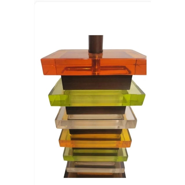 A beautiful Mid Century Modern stacked lucite table lamp. The lamp reminds me of the color of a roll of lifesavers. The...
