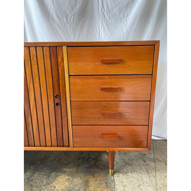A pair of walnut credenzas attributed to Micheal Van Beuren. With research and without a tag or makers mark, we concluded...