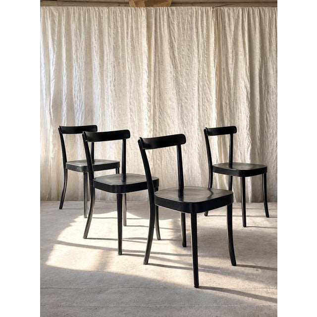 An elegant set of four wooden dining chairs featuring Werner Max Moser's iconic 1-250 design, originally introduced in...