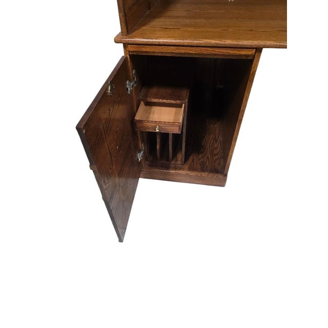 Handsome Winners Only solid oak roll top desk featuring classic American craftsmanship and extensive storage. This...