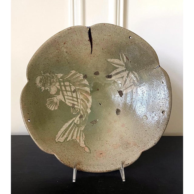 A glazed stoneware Ishizara (food serving platter) from Seto kilns. The platter features an unusual lobed edge and a...