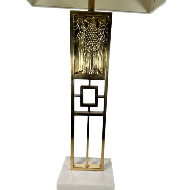 A striking continental style table lamp crafted in solid brass and mounted on a substantial Carrara marble base resting on...