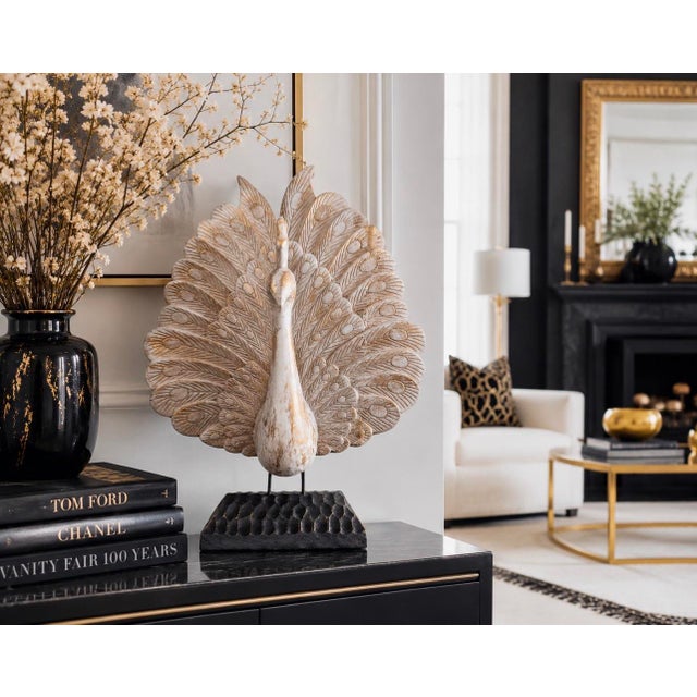 Bring sculptural elegance and artisan craftsmanship into your home with this striking hand-carved wooden peacock...