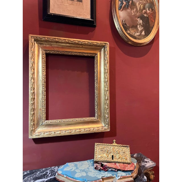 Elegant italian empire period gilt wood frame crafted in tuscany, dating from the early 19th century. this richly carved...