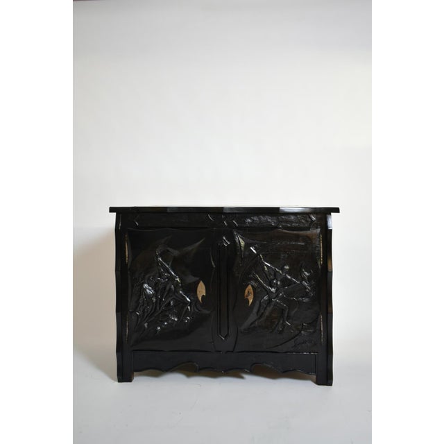 Oak brutalist sideboard, cabinet, chest of drawers opening with two doors and adorned with a rich carved decoration...