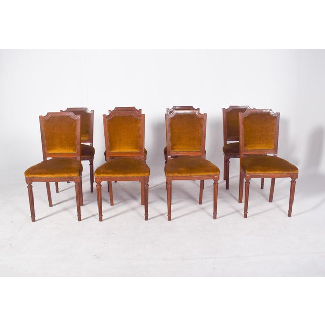 Set of eight dining chairs. In carved wood, with a neoclassical structure. The backs have an upper cut-out with a slightly...