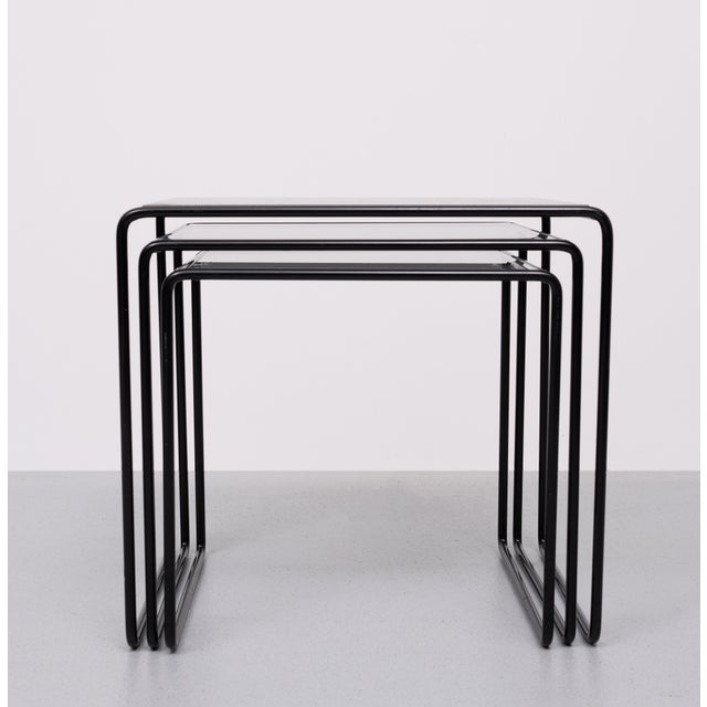 Very nice Vintage nesting tables, set of 3 Black metal frame comes with Glass tops .Bauhaus in style . Good condition .