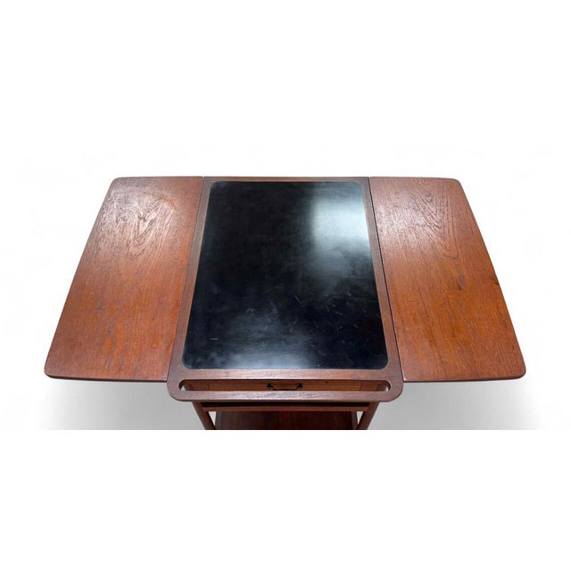 A beautifully crafted Danish Modern teak bar trolley designed by Ludvig Pontoppidan, showcasing the refined detail and...