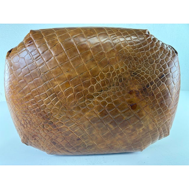 This is a Ralph Lauren Regency inspired leather and walnut vanity bench. The small bench has a tan faux crocodile leather...