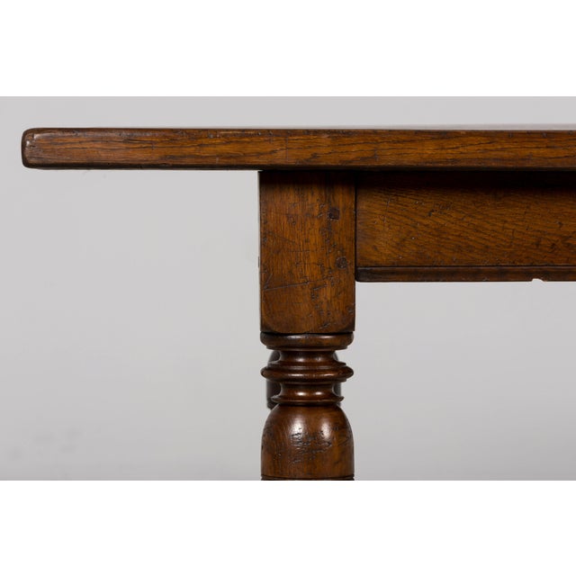 A handsome late 19th-century French Louis XIV style dining table, crafted from solid oak and sourced in Provence, France....