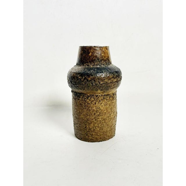 A French stoneware pot from the 1960s, exemplifying the post-war revival of handcrafted ceramics. Its architectural and...