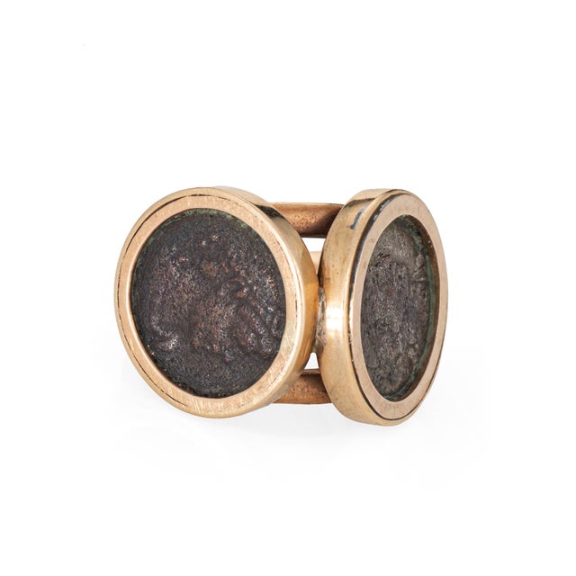Stylish vintage double ancient coin ring crafted in 14 karat yellow gold (circa 1970s). Two ancient coins measure 12mm....