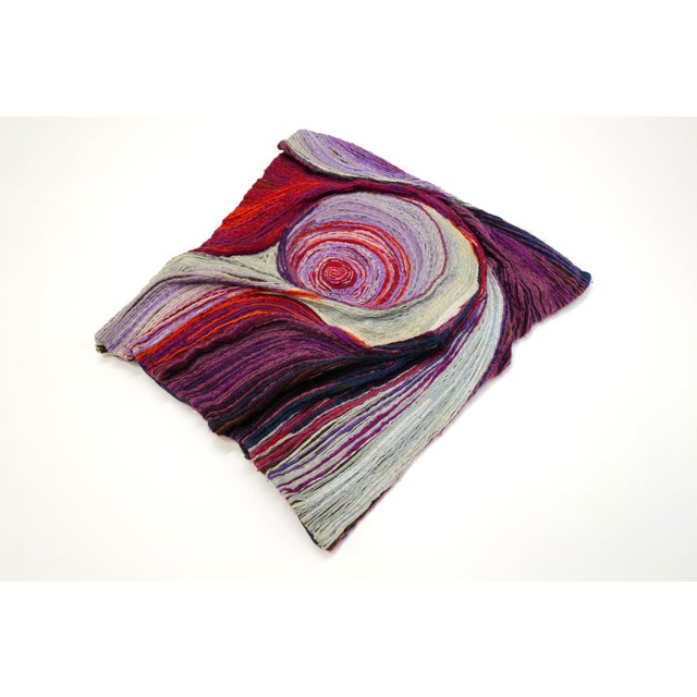 Janet Kuemmerlein's stunning fiber art piece, measuring 24”x 26”, is a captivating exploration of color and texture. With...