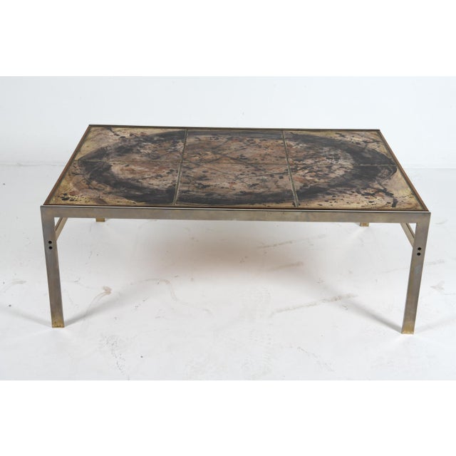 striking danish coffee table by birte vedel howard, crafted in the 1970s. the design features a hand-tiled top set within...