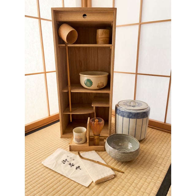 A refined vintage Japanese portable matcha tea ceremony set (chabako), thoughtfully assembled and presented in its...