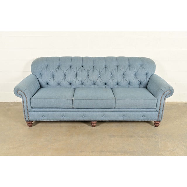 An elegant and exceptionally comfortable traditional Chesterfield style sofa In the manner of Baker Furniture By Smith...