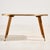 A mosaic-topped coffee table with organic patterns from the 1960s. The table’s edge and oak legs feature brass details and...