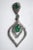 A pair of emerald and diamond tear drop dangle earrings. The post and center feature large, oval faceted emeralds and...