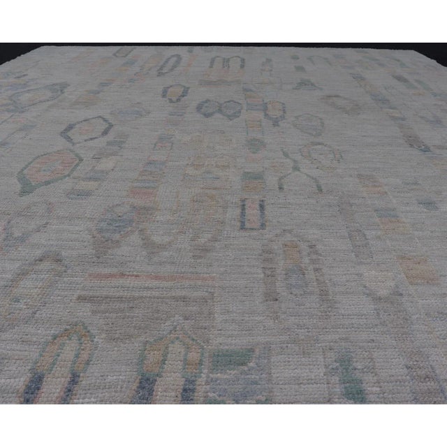 Measures: 9'0 x 11'11 Modern Tribal Rug with Soft Gray and Pastel Geometric Patterns 9'0 x 11'11. Keivan Woven Arts; rug...