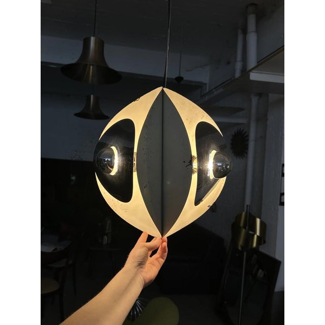 A rare italian space age chandelier attributed to goffredo reggiani, 1970s. Designed in chrome and enamelled metal, the...